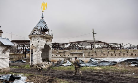 A solider walks past a destroyed monastery in Dolyna, eastern Ukraine on 26 December, 2022.