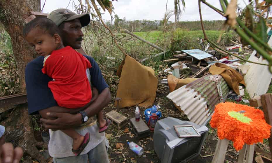 A Fijian resident  looks at the damage  caused by Cyclone Winston
