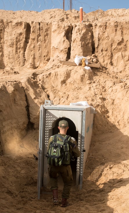 An Israeli soldier prepares to enter to a tunnel