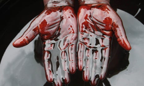 A man covers his hands in crude oil during a protest against oil spills in Bonga, Nigeria. 