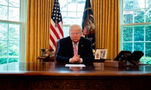Donald Trump prays at his desk in the Oval Office, as he participates in an Easter Blessing.