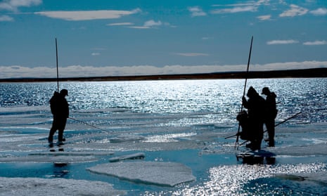 Fishing on ice in Gjoa Haven, King William Island, Nunavut, Canada. The region has witnessed a growing number of accidents in which hunters unexpectedly plunge through ice.