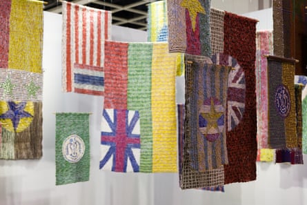 Woven material that resemble real flags, featuring stripes and stars in various colours, hanging from the ceiling