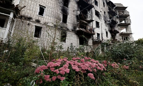 Flowers are pictured beside a destroyed building in the recently liberated town of Izium in the Kharkiv region.