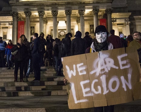 A masked protester in Trafalgar Square
