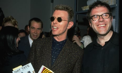 David Bowie with critic Matthew Collings – and Jeff Koons behind – at the launch party in 1998 of William Boyd’s book Nat Tate: an American Artist 1928-1960.
