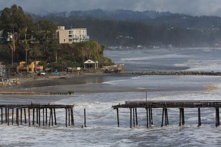 A damaged pier is seen in Santa Cruz after an ‘atmospheric river’ slammed into the state on 5 January.