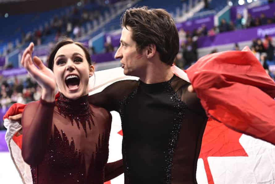 Tessa Virtue and Scott Moir celebrate after becoming Olympic champions