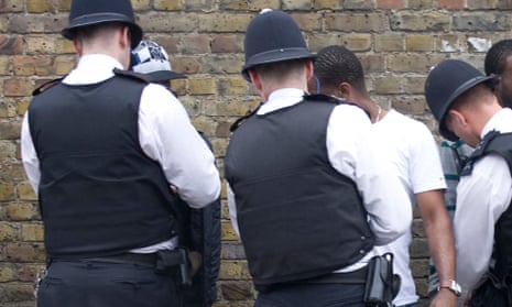 Black men being stopped and searched by police officers.