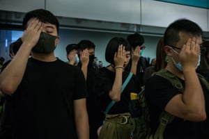 Protesters cover their right eye in solidarity with a medic who was shot in the face by police. Hong Kong, 21 August 2019