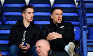 Phil Neville and his son Harvey Neville watch from the stand.