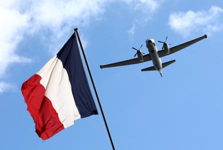 A Dassault Atlantic ATL 2 flies past a French national flag during a military training exercise.