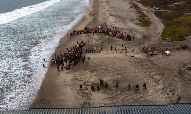 Activists demonstrating against US migration policies gather near the US-Mexico border fence at Imperial beach in San Diego.