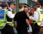 Met police officers try to defuse tension between rival fans as they leave the ground after the Premier League match between Arsenal and Chelsea