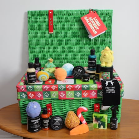 Lush beauty Advent calendar open on a table, with its beauty products arranged alongside it