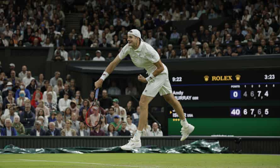 John Isner serves for the match against Andy Murray.