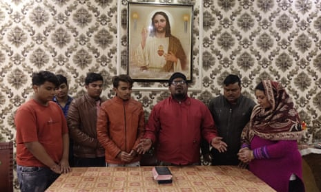 A pastor is conducting a special prayer for a Christian family in Aligarh. Indian Christians make up approximately 2.3% of the country’s population.
