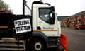 A sign saying POLLING STATION attached to a white lorry with Dudley metropolitan borough council on its door outside a polling station with houses in background