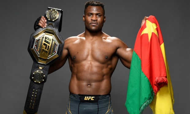Francis Ngannou holds the flag of Cameroon and his Ultimate Fighting Championship belt after winning the UFC 270 event in California in January.