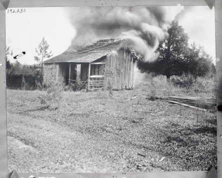 A black resident’s home in shown in flames during the race riots in 1923.