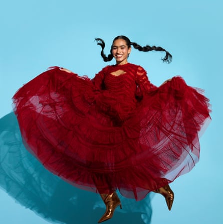 ‘At a dance class, we are moving our bodies, having a laugh and our phones are nowhere to be seen. That’s not just joy, that’s wellness!’ Photograph of a model in a long purple dress jumping in the air