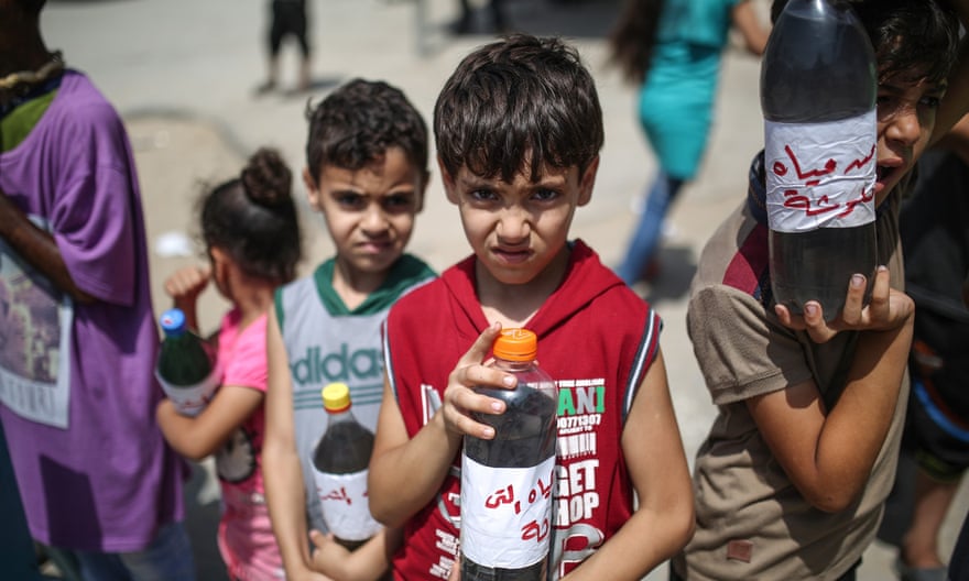 Children at a protest demanding clean water stand before Beit Hanoun border gate in Gaza City