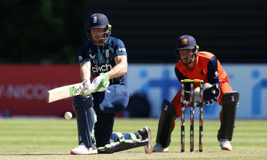 Jos Buttler, who hit the winning runs, plays a shot with one knee on the ground and the Netherlands wicket-keeper looking on