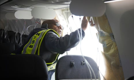 NTSB investigator-in-charge John Lovell examines the fuselage plug area of Alaska Airlines Flight 1282 in Portland, Oregon