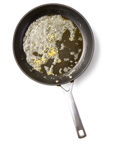 Felicity Cloake’s pasta al limone 02a. While the pasta is cooking, melt the butter in a wide pan until foaming, add most of the grated lemon zest, then turn off the heat until the pasta is ready. When the pasta is al dente, or done to your liking, scoop out and set aside a small cupful of the pastaits cooking water, then drain the pasta well. Turn on the heat under the butter and lemon zest pan to medium-high underneath the butter pan