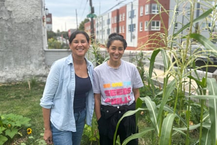 two sisters smile in a garden