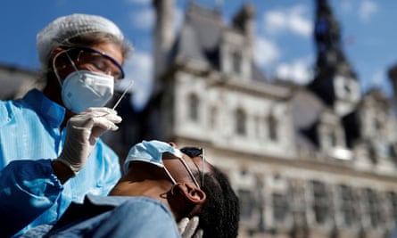 A health worker prepares to administer a swab test in Paris.