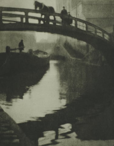 A horse and figures cross an arched bridge over Regent’s Canal, with reflections below