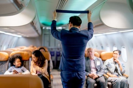Airline staff man demonstration and explain about safety tools holding a safety belt