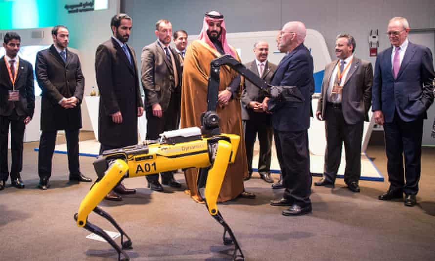 Crown Prince Mohammed bin Salman, centre, inspects at a quadruped robot during his visit to the Massachusetts Institute of Technology (MIT) in Cambridge, Massachusetts.