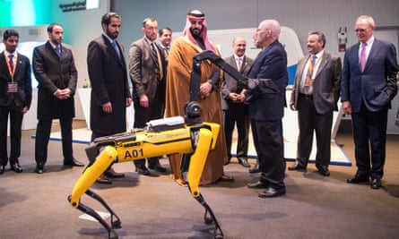 Crown Prince Mohammed bin Salman, centre, inspects at a quadruped robot during his visit to the Massachusetts Institute of Technology (MIT) in Cambridge, Massachusetts.