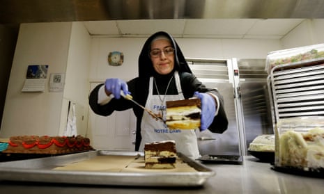 Sister Mary Valerie places cake on a tray to serve at the Fraternite Notre Dame Mary of Nazareth soup kitchen in San Francisco.