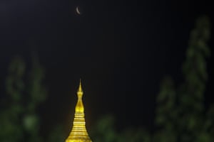 The moon rises above Shwedagon pagoda in Yangon, Myanmar