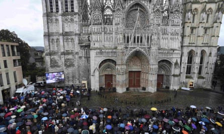 People watch the funeral service from outside the cathedral