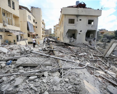 Residents checking destruction caused by Israeli airstrikes in Ansariyeh