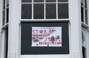 A sign about deforestation in the window of a house in St Ives