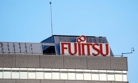Fujitsu sign in red lettering on white, on the roof of the firm’s UK head office