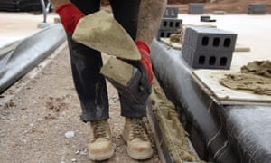 A construction worker builds a home