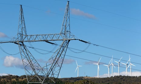 High tension power lines stand near the wind turbines