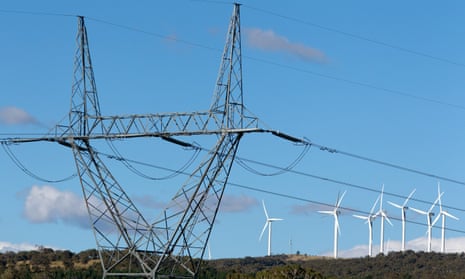 High tension power lines stand near the wind turbines operating on Capital Wind Farm in Bungendore, Australia.