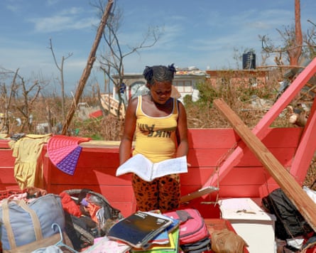 Andrieneke Hyman, 13, looks at her wet notebook in her damaged room, in the aftermath of Hurricane Melissa in Saint Elizabeth Parish, Jamaica.