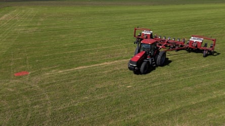 A tractor pulling planting equipment on a soya bean field in the US.