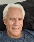 A smiling man with gray hair