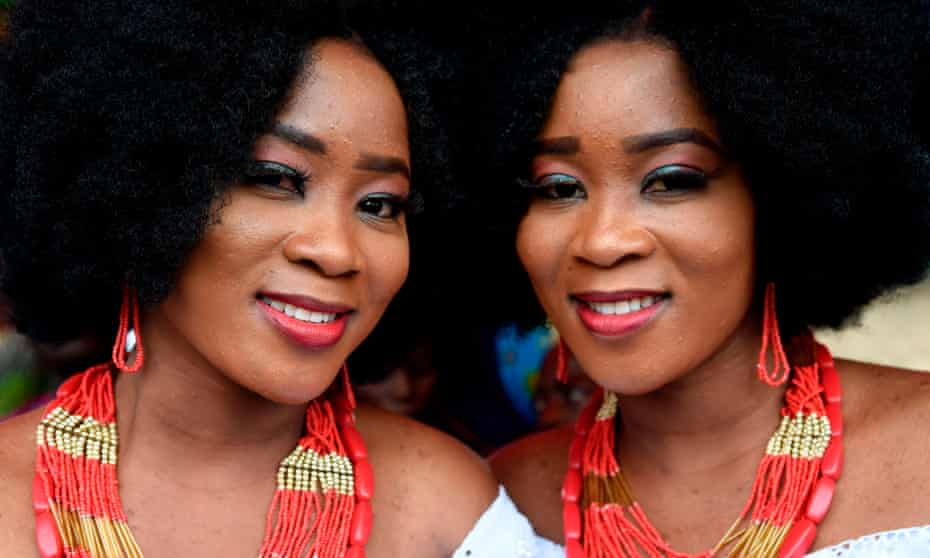 Identical twin sisters Kehinde Olofin (L) and Taye Olofin (R) attends Igbo-Ora World Twins festival