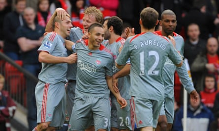 Andrea Dossena (left) is congratulated by Liverpool teammates after sealing a 4-1 win at Manchester United.