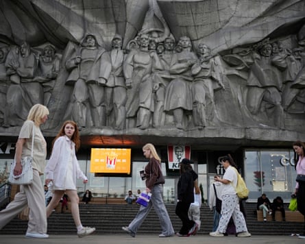 People walk next to a 1979 ‘Solidarity’ bas-relief in Minsk.